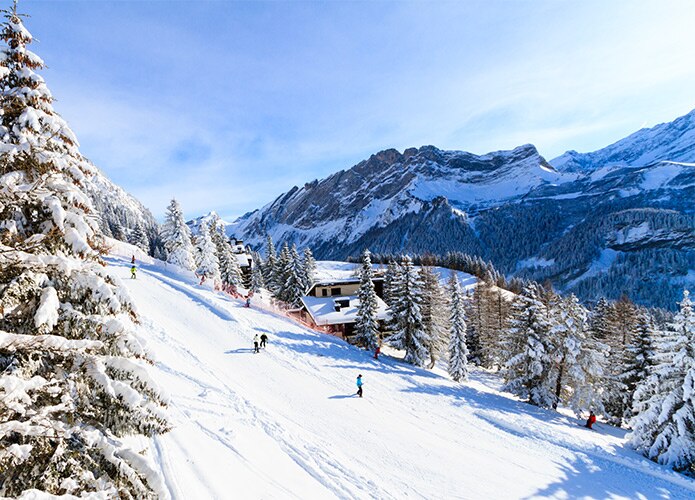 People skiing on mountain in distance