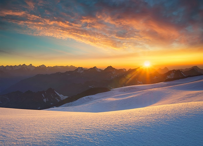 Sunset over snowy mountains