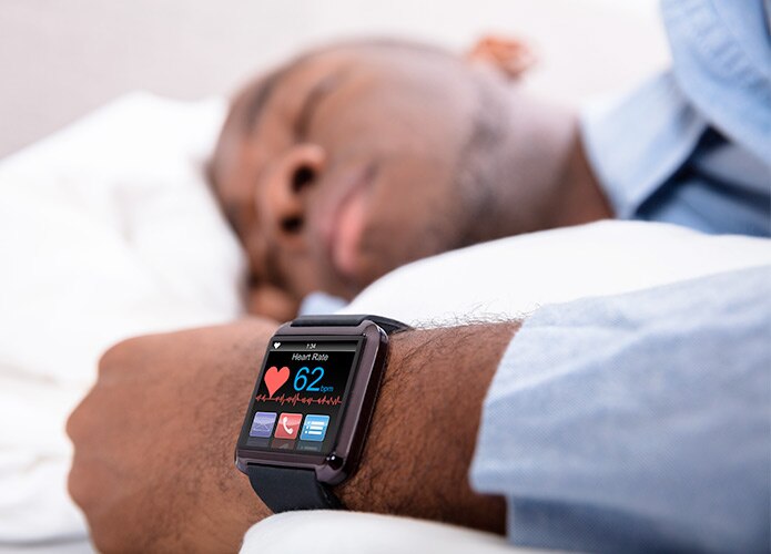 Man sleeping wearing smart watch